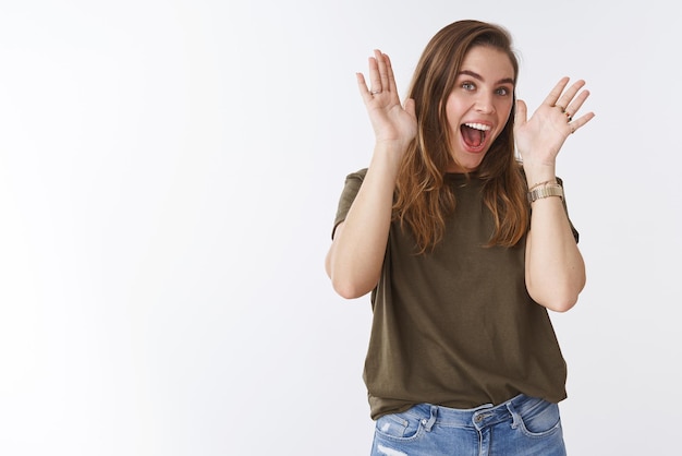 woman peek-a-boo playing smiling broadly having fun mimicking hilarious grimaces open face raising palms near head