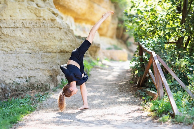 Woman performs the Urdhwa Prasarita Ekapadasana exercise a tilt with an upstretched leg