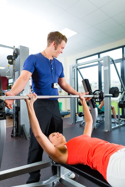 woman and Personal Trainer in gym