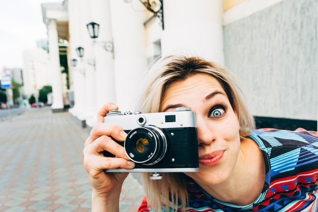 Woman photographed retro camera in the city