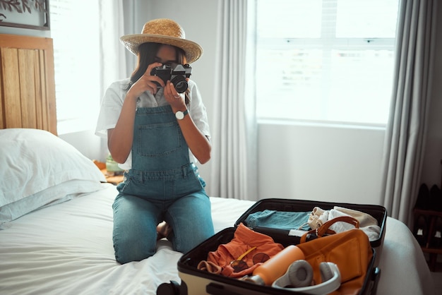 Woman photographer or camera picture of suitcase for summer holiday vacation break or content marketing for creator blog Travel influencer digital photography or luggage objects in hotel bedroom