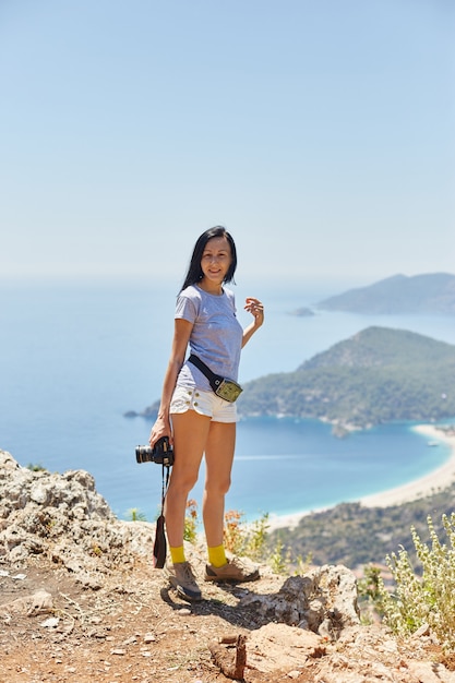 Woman photographer walks along the Lycian Way trail. Fethiye, Oludeniz. Beautiful view of the sea and the beach. Hiking in the mountains of Turkey