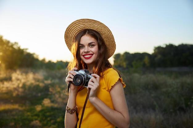 Woman photographer with camera in hands a snapshot of nature fresh air