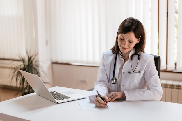 Woman physician prescribing medication.