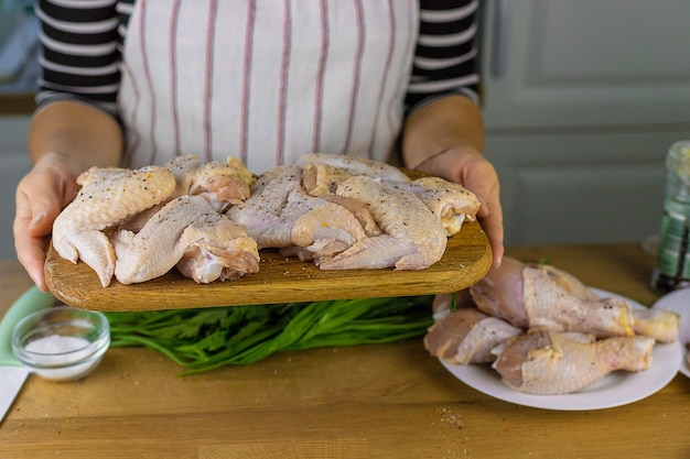 Woman pickling chicken meat selective focus