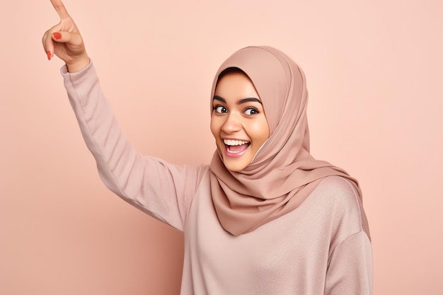 A woman in a pink hijab points to the sky