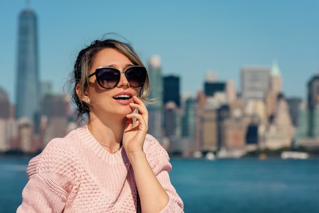 Woman in pink sweater posing in New York