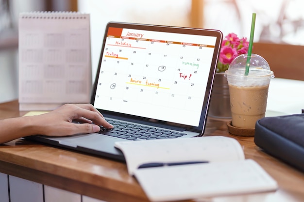 Woman planning agenda and schedule using calendar event planner