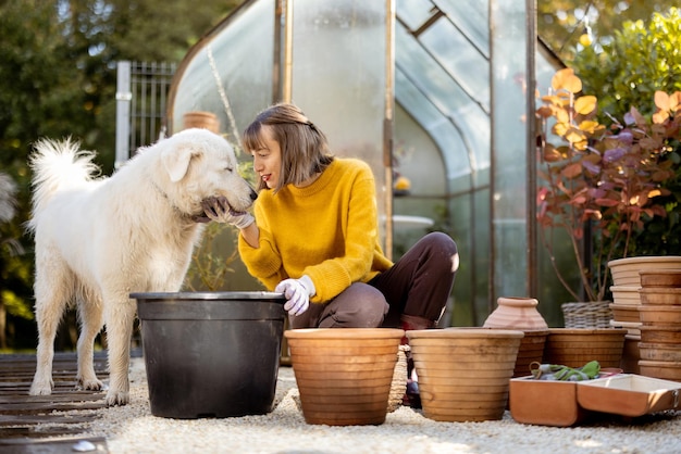 Woman planting flowers in jugs at garden