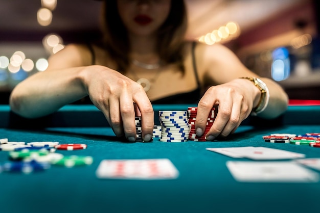 Woman play poker game and doing bet, casino