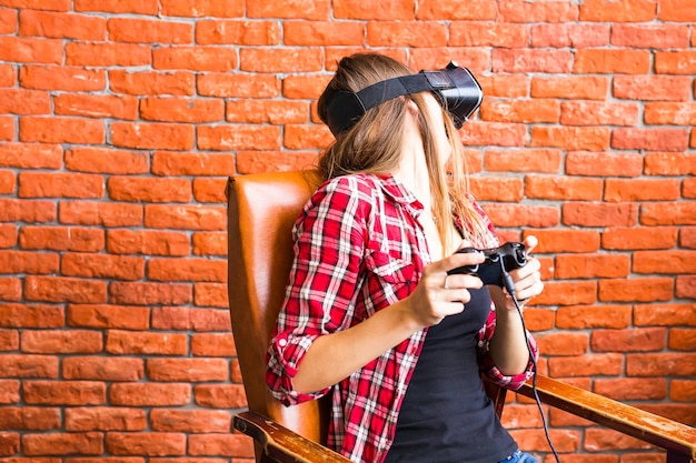 Woman play video game with joystick and VR device.