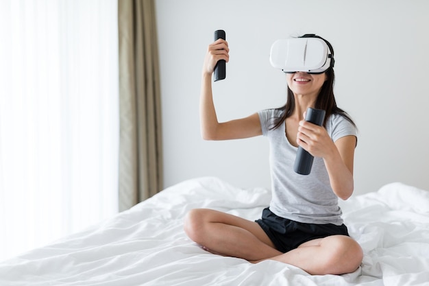 Woman play with VR device at home