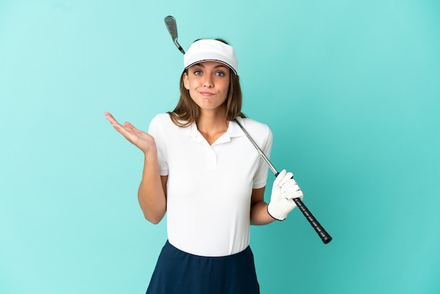 Woman playing golf over isolated blue background having doubts while raising hands