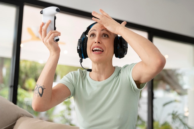 Woman playing a video game with her console