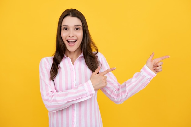 Woman point at copy space showing copyspace pointing Promo girl showing advertisement content gesture pointing with hand recommend product