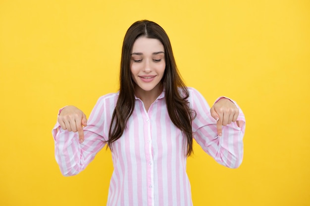 Woman point down at copy space showing copyspace pointing Promo girl showing advertisement content gesture pointing with hand recommend product Isolated background