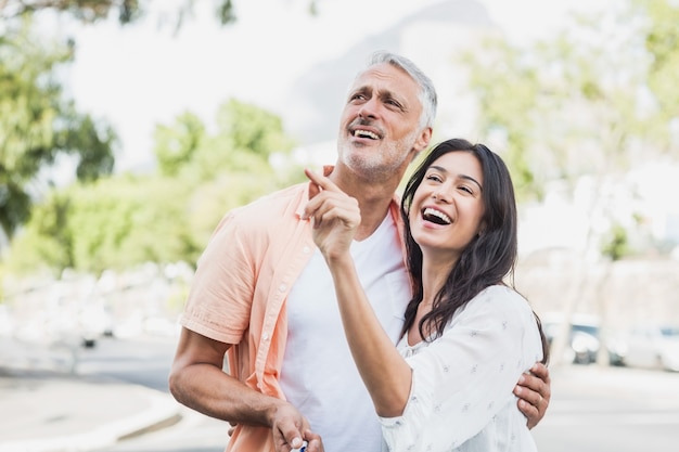 Woman pointing to happy man