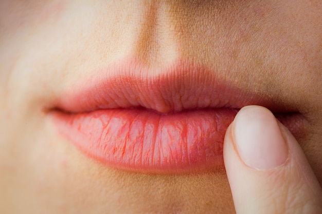 Woman pointing to her lips