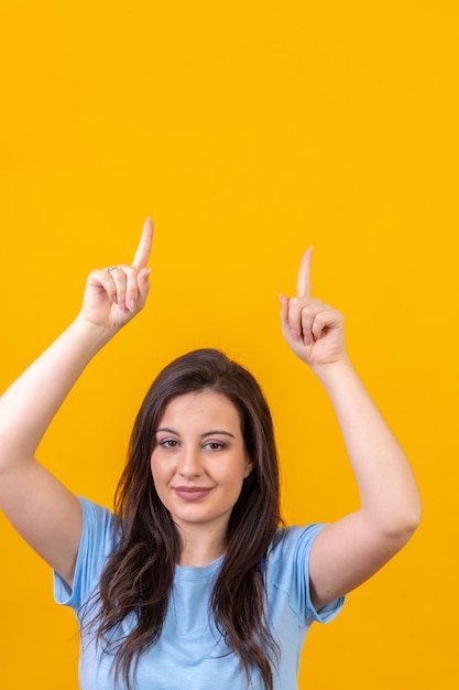 Woman pointing up to a blank space