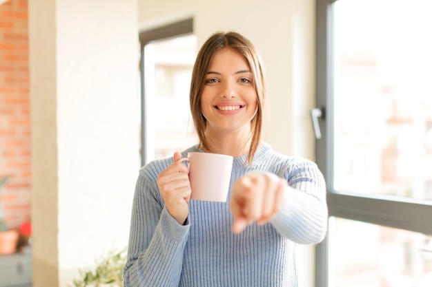 woman pointing with finger, confident, friendly smile, choosing you