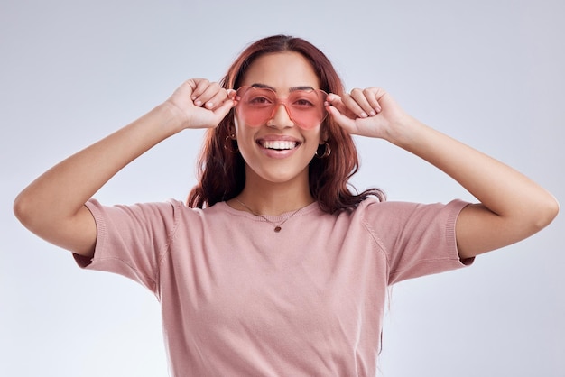 Woman portrait and fashion sunglasses with smile vision and retro isolated on white background Happy female person gen z and funky style vintage and cool eyewear with stylish accessory in studio