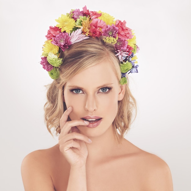 Photo woman portrait and flowers on crown in studio with makeup and confidence for cosmetics beauty and skincare spring aesthetic model and face or floral headband with wellness on white background