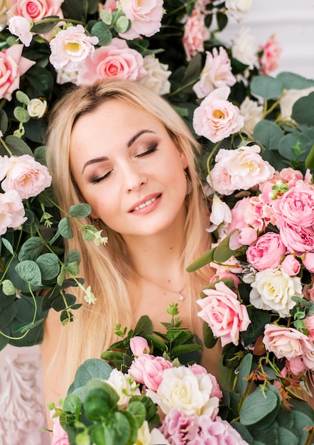 Woman posing in a studio with roses