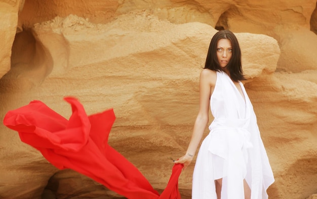 Woman posing wit red fabric outdoor