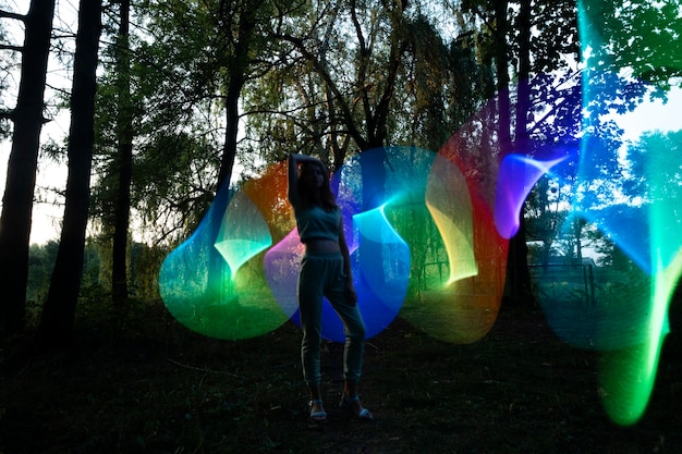 Woman posing with colorful lights full shot