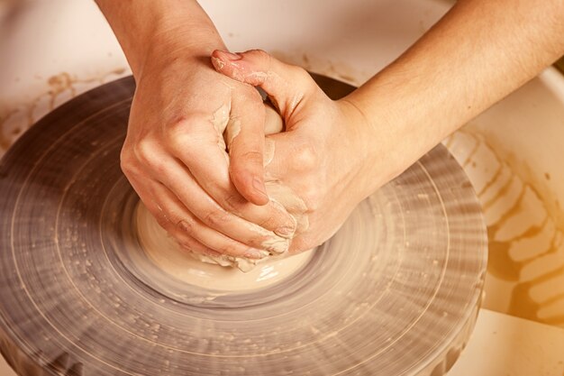 Woman potter sculpts a clay 