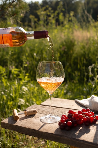 Woman pouring rose wine into a glass