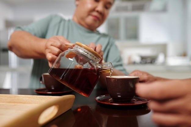 Woman Pouring Tea for Husband