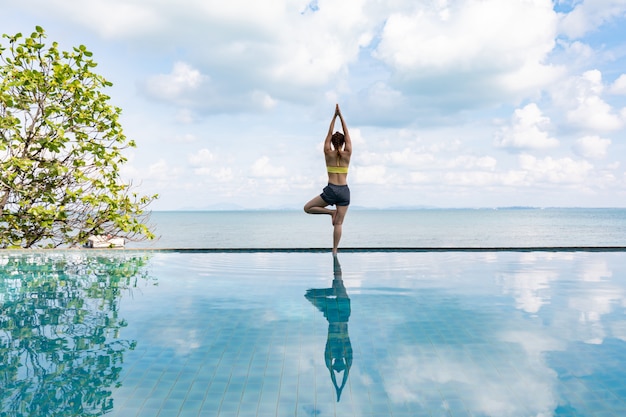 Woman practices yoga lotus pose