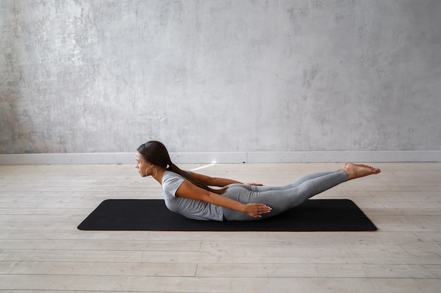 Woman practicing advanced yoga.