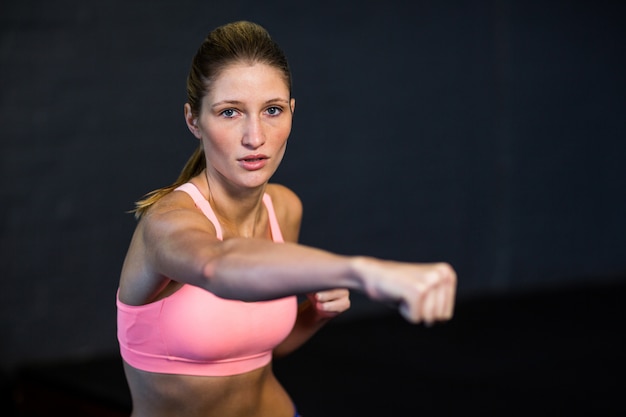 Woman practicing boxing in fitness studio