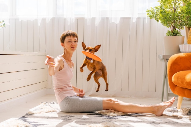 Woman practicing exercising with dog to enjoying and relaxing with yoga Spend