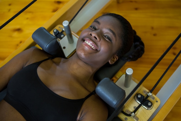 Woman practicing pilates on reformer