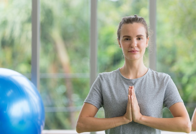 woman practicing yoga at gym