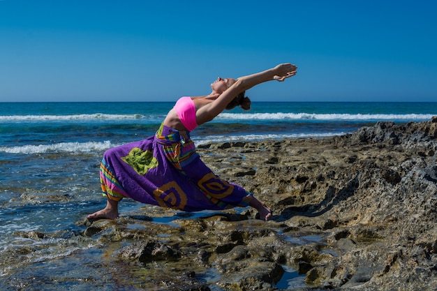 Woman practicing yoga at sea