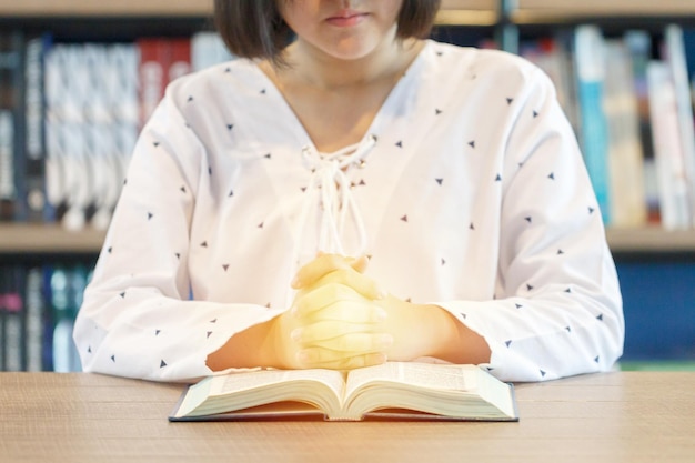 Woman praying over a bible. Pray and bible concept