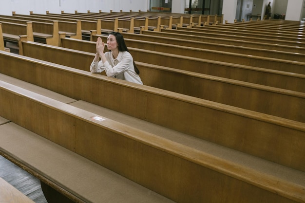 Woman praying to God in church