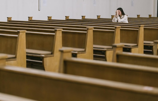 Woman praying to God in church