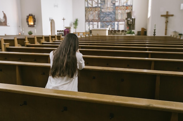 Woman praying to God in church