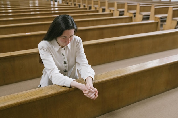 Woman praying to God in church