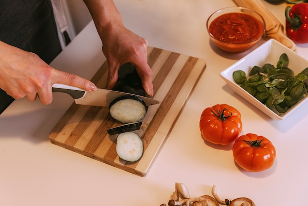 Woman preparing delicious pizza with healthy ingredients. Home made concept.