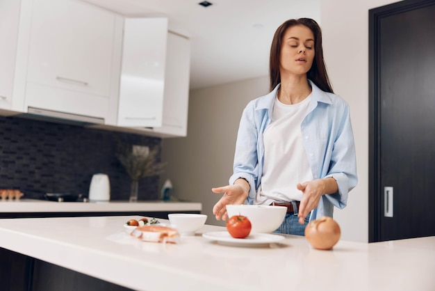 A woman preparing a healthy meal with fresh vegetables in a cozy kitchen setting