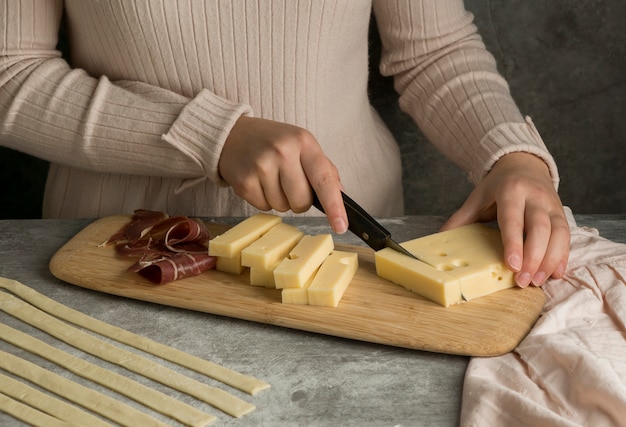 Woman preparing some traditional tequenos