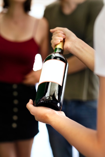 Woman presenting a bottle of red wine