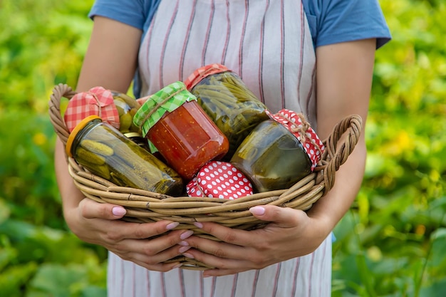 A woman preserves vegetables in jars Selective focus