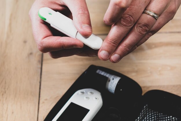 Woman pricking her finger to check blood glucose level with glucometer for diabetes